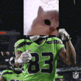 a football player wearing a green jersey with the number 83