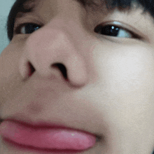 a close up of a person 's face with a pink tongue
