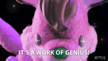 a pink stuffed animal with the words " it 's a work of genius " below it