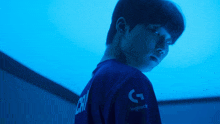 a man wearing a blue shirt that says logitech on it