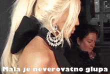 a woman in a black dress with the words mala je neverovatno glupa written on the bottom