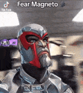 a man with a beard is wearing a mask that says fear magneto on it .