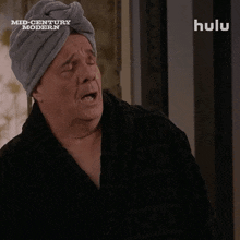 a man with a towel wrapped around his head is on a hulu ad