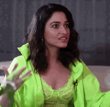 a woman wearing a neon green jacket and a green top