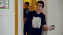 a man wearing a black shirt with a picture of metallica on it
