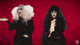 a drag queen and a bride are standing next to each other with a red background