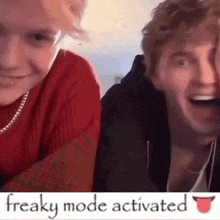 two young men are sitting next to each other with their mouths open .