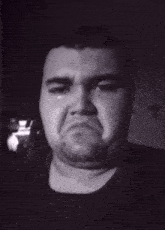 a black and white photo of a man making a face