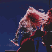 a woman in a crop top is holding a microphone