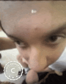 a close up of a child 's face with a watermark that says www.cutour.pro on it