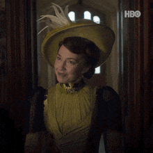 a woman in a yellow dress and hat says i don 't mean to interrupt