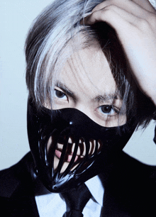 a man wearing a black mask with a mouth on it