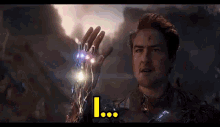 a man in a suit is holding a glowing hand with the word i on it .