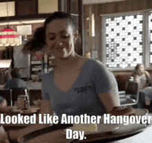 a waitress is smiling and holding a tray of food with the caption " looked like another hangover day " below her