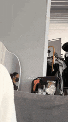 a person wearing a mask is standing in front of a mirror