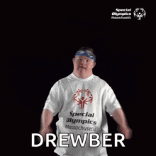 a man with down syndrome is wearing a special olympics t-shirt and swimming goggles .