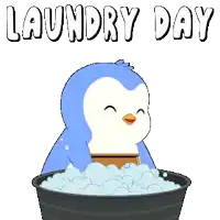a blue and white penguin is sitting in a laundry basket