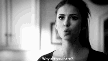 a black and white photo of a woman making a funny face and saying `` why are you here '' .