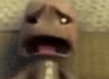 a close up of a person 's face with their mouth open and a blurred background .