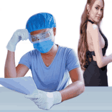 a man wearing a surgical mask and goggles is looking at a laptop
