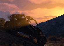 an atv is driving down a hill at sunset
