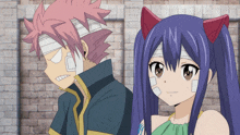 a boy with bandages on his head stands next to a girl with bandages on her head