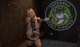 a woman stands in front of a ghost pirate logo