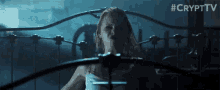 a woman in a white tank top is sitting on a bed with the hashtag #crypttv