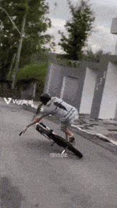 a man is riding a motorcycle down a street with a viggle.ai watermark in the corner