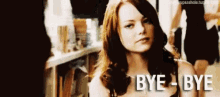 a woman with red hair is sitting in a room with the words `` bye bye '' written on her face .