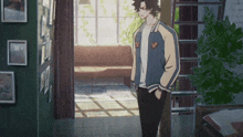 a man in a bomber jacket stands in a hallway