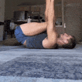 a man is laying on his back with his legs up in the air