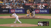 a baseball game is being played in front of a us bank banner