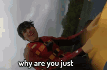 a man in a red life jacket is asking why are you just