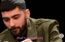 a man with a beard says that 's very fruity in pink letters
