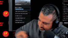 a man wearing headphones talks into a microphone while playing a game