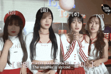 a group of girls are standing next to each other and one of them says the weather is so cold ..