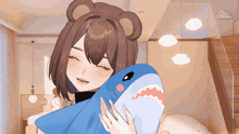 a girl with a teddy bear head is holding a blue stuffed shark
