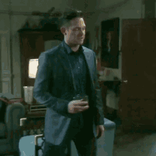 a man in a suit is walking into a room