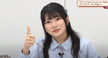 a girl in a blue shirt is holding a spoon in her hand