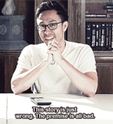 a man with glasses is sitting at a table with his hands folded and says this story is just wrong the premise is all bad