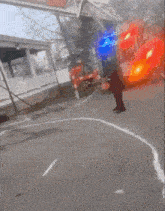 a fire truck is parked on the side of the road and a man is standing in front of it