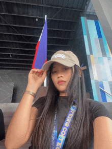 a woman wearing a hat and a lanyard that says it 's a college