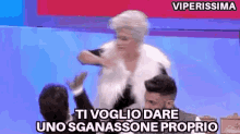 a woman in a white fur vest is giving a high five to a man in a suit