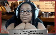 a woman wearing glasses and headphones with the name d hane monk on a sign