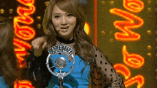 a woman stands in front of a microphone with ladies cole written on her shirt