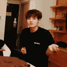 a young man wearing a black shirt that says obey