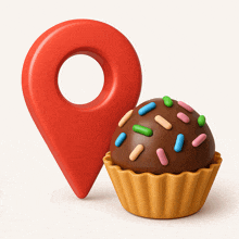 a cupcake with sprinkles is next to a red map pin