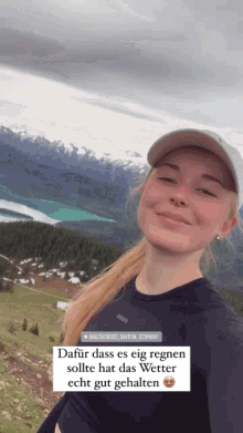 a woman standing on top of a mountain with the words dafür dass es eig regnen