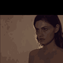 a close up of a woman 's face with a brown background